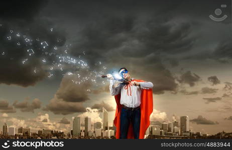 Superman playing violin. Young man in superhero costume playing violin