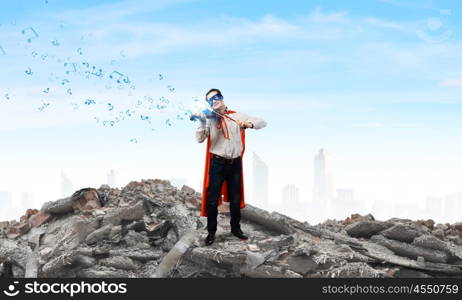 Superman with violin. Young man in superhero costume playing violin