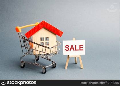Supermarket cart with houses and a Sale Poster. The concept of selling a home, real estate services or buying from the owner. Buying and selling real estate, property, apartments. Selective focus