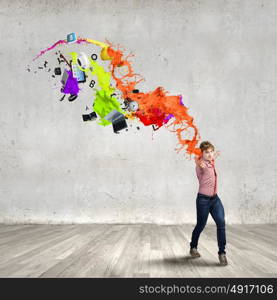 Supernormal man. Young man in casual throwing colorful paint splashes