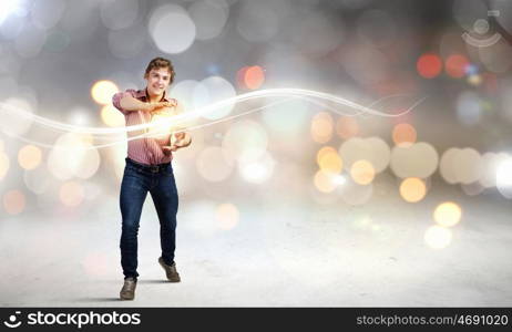 Supernormal man. Young man in casual throwing light splashes