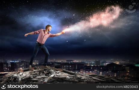 Supernormal man. Young man in casual throwing star dust