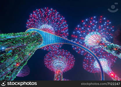 Supertree Grove. Garden by the bay or outdoor artificial trees in Marina Bay area in urban city of Singapore Downtown at night. Landscape background