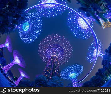 Supertree Grove. Garden by the bay or outdoor artificial trees in Marina Bay area in urban city of Singapore Downtown at night. Landscape background