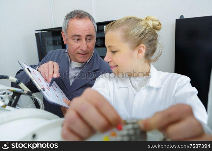 supervisor instructing young female engineer