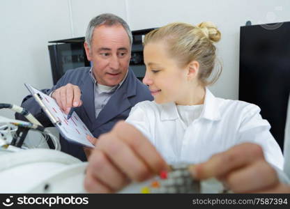 supervisor instructing young female engineer