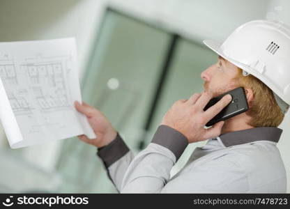 supervisor of construction talking phone