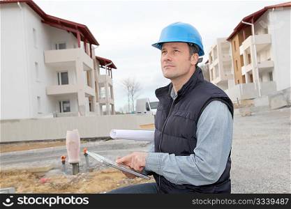 Supervisor using electronic tab on construction site
