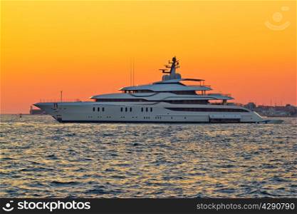 Superyacht on yellow sunset side view