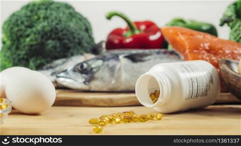 Supplement Bottle with Gel Capsules On a Wooden Table. Natural Food Sources of Vitamin D In Background. . Vitamin D Gel Capsules and Natural Sources of Vitamin D