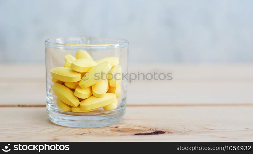 supplementary food or medicine in a glass on a wooden background.