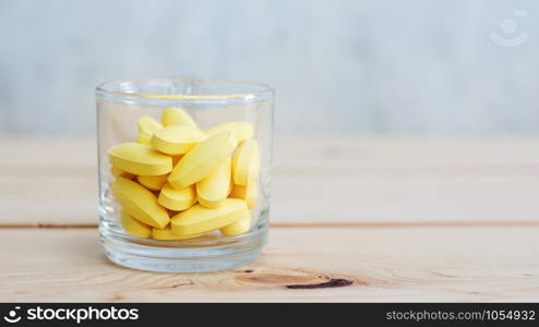 supplementary food or medicine in a glass on a wooden background.