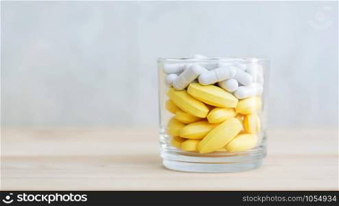 supplementary food or medicine in a glass on a wooden background.