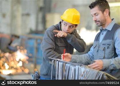 supplier with engineer checking on production in factory