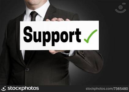 Support sign is held by businessman.. Support sign is held by businessman