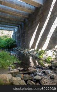 Support structure casts shadows onto a wall at the Des Moines Creek Trail in Washington State.