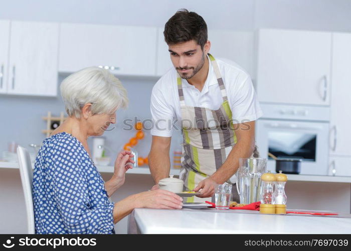 supportive caregiver looking at his senior female charge