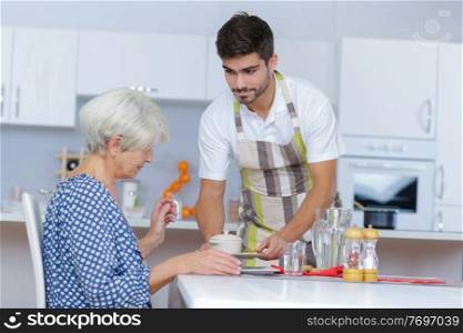 supportive caregiver looking at his senior female charge