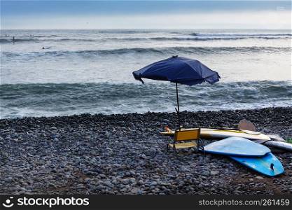 surf boards and beach umbrella evening