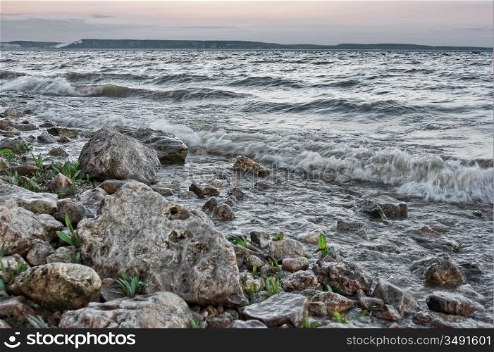 surf on rocky shore in evening. HDR