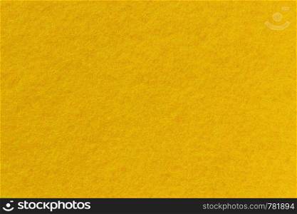 Surface of felt close-up. Yellow background, seamless texture.