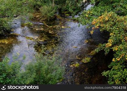 Surface of travertine pond in autumn