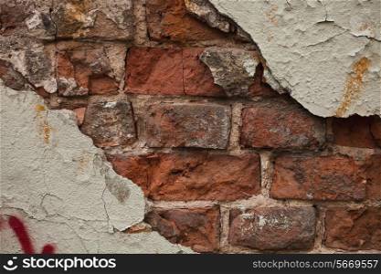 surface texture brick wall with cracked plaster close up