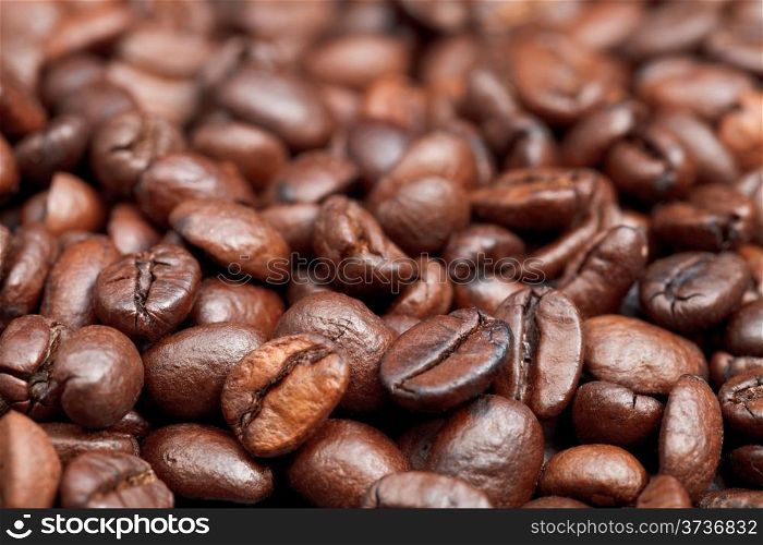 surface with roasted coffee beans close up
