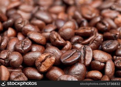 surface with roasted coffee beans close up