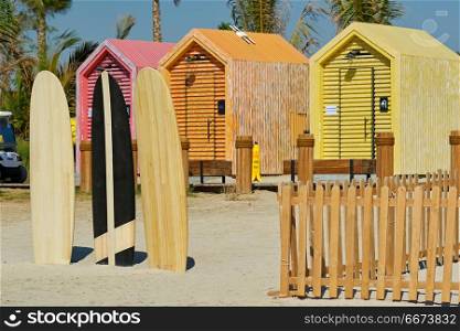 Surfboards and bathing cabins in Dubai. Surfboards and beach bathing cabins in Dubai, United Arab Emirates