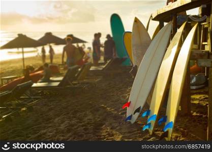 Surfboards for rent on Bali beach at sunset