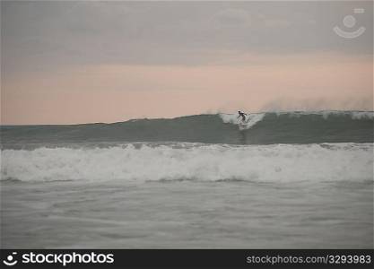 Surfer along Mal Pais coastline in San Jose Costa Rica