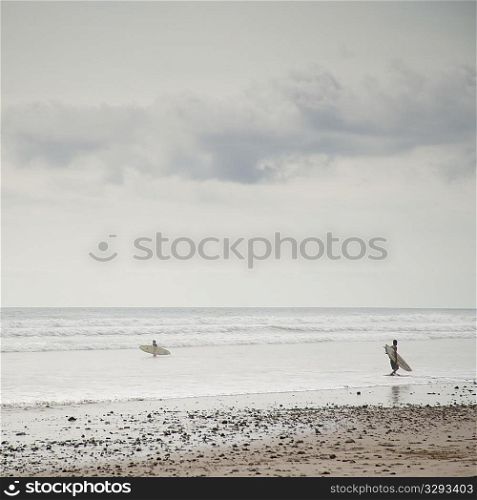 Surfer along ocean seashore in Costa Rica