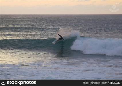 Surfer Catching Wave