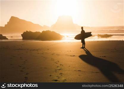 Surfer checking the waves at sunset