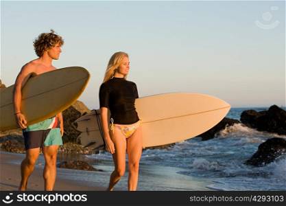 Surfer couple at the beach