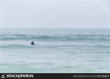 Surfer girl waiting for waves in Furadouro beach, Ovar - Portugal.