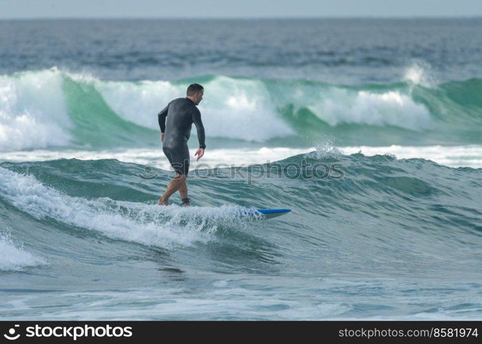 Surfer in action at sunset. Furadouro beach, Ovar - Portugal.