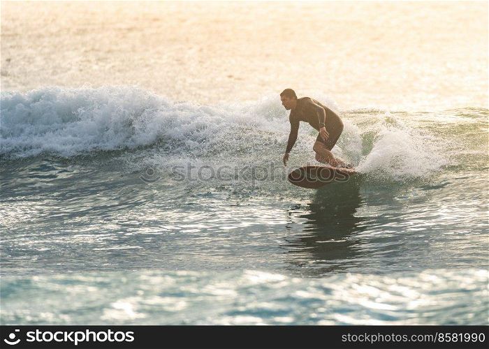 Surfer in action at sunset. Furadouro beach, Ovar - Portugal.