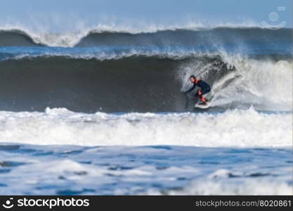 Surfer in action on the ocean waves on a sunny day.