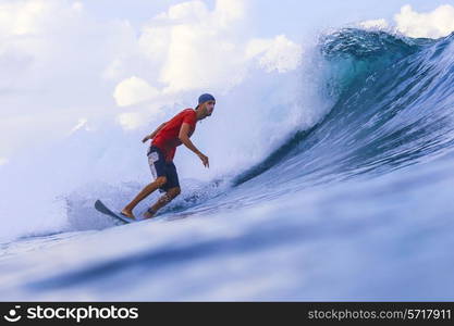 Surfer on Amazing Blue Wave, Bali island.