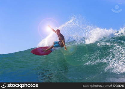 Surfer on Amazing Blue Wave, Bali island.