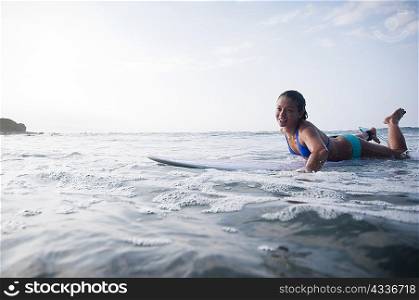 Surfer paddling in calm water
