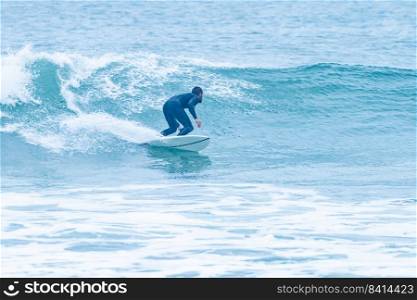 Surfer rides the ocean wave during the morning. Extreme sport and active lifestyle concept.