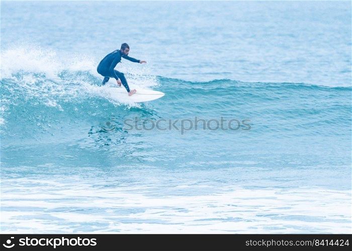 Surfer rides the ocean wave during the morning. Extreme sport and active lifestyle concept.
