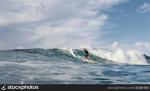 surfer riding wave daylight