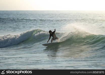 Surfer riding waves with a short board in Furadouro beach, Portugal. Men catching waves in ocean. Surfing action water board sport.