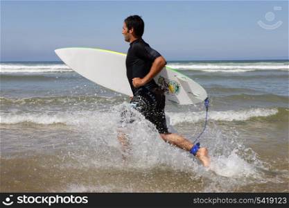 Surfer running with board