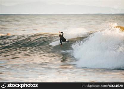 Surfer surfing ocean wave, Santa Barbara, California, USA