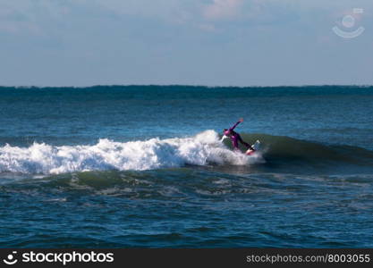 surfer violet wetsuit riding the wave